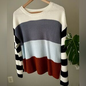 Striped color-block crewneck sweater.